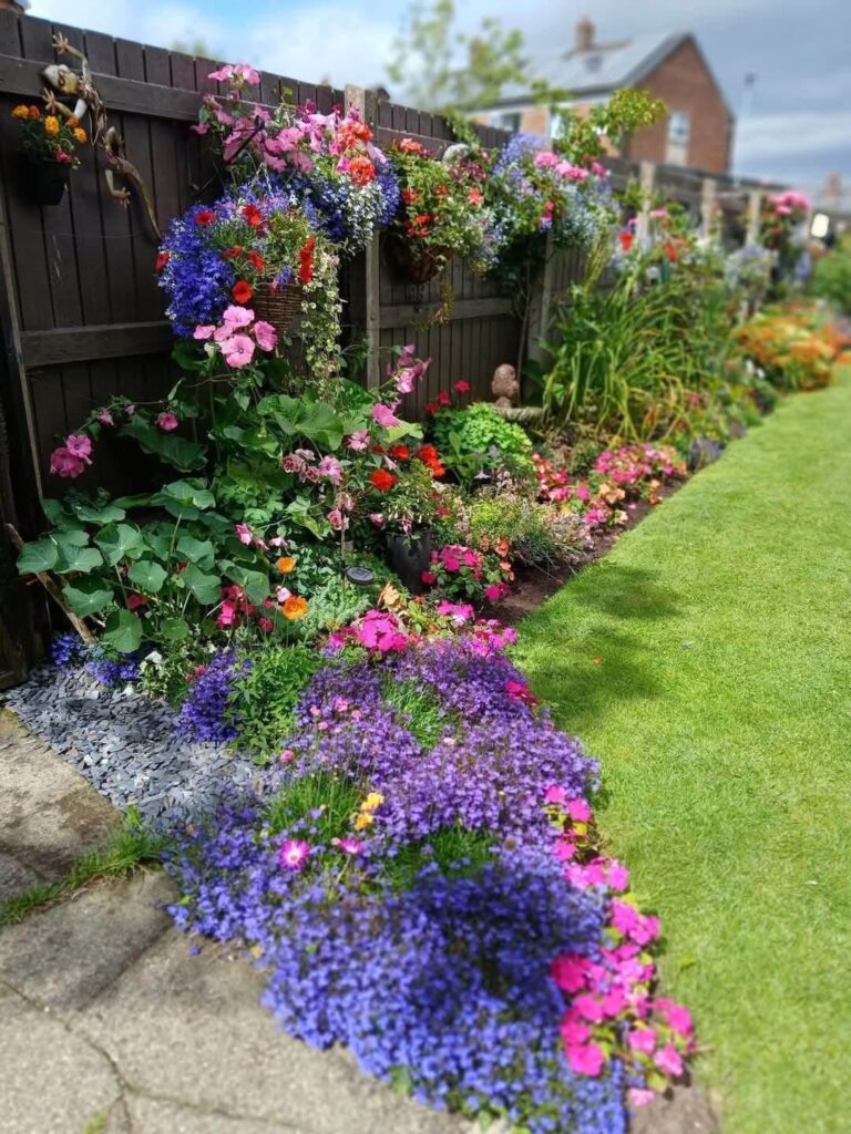 Colourful flower border beside a neatly edged lawn