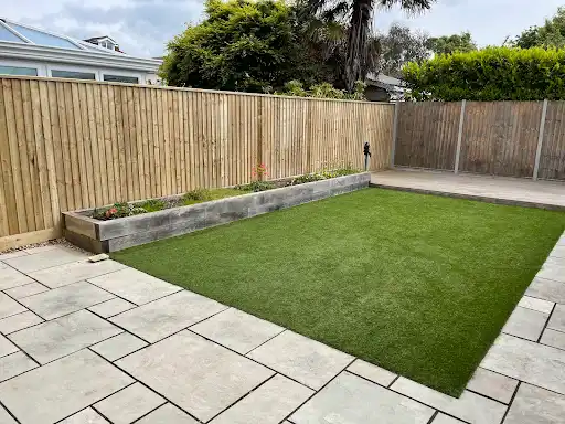 Artificial lawn with a timber border, new patio and fencing