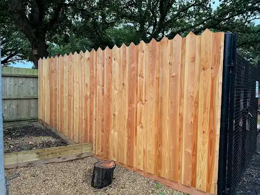 Tall featheredge fence along a side garden