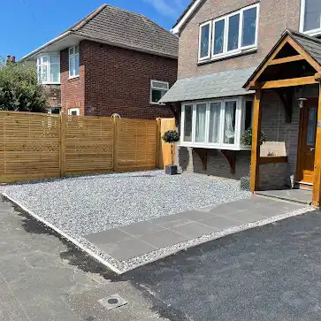 Slatted front garden fence with gravel and a new path