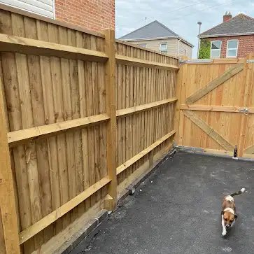 Closeboard fence and matching gate across a driveway